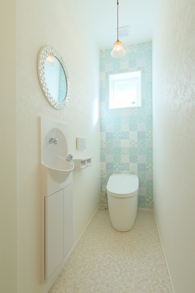 Danish powder room photo in Other with open cabinets, a vessel sink and wood countertops