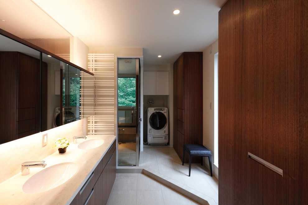 Photo of a large modern cloakroom in Tokyo with beaded cabinets, medium wood cabinets, white tiles, porcelain flooring, an integrated sink, solid surface worktops, white floors and white walls.
