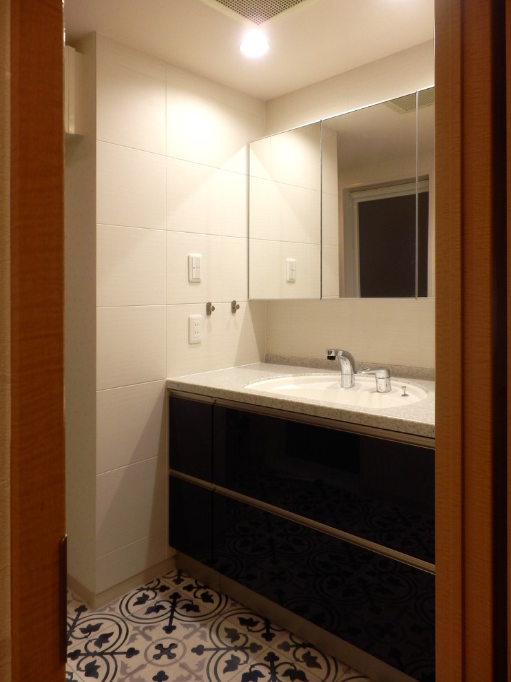 Small classic cloakroom in Tokyo Suburbs with blue cabinets, white tiles, solid surface worktops, grey worktops, white walls, vinyl flooring and blue floors.