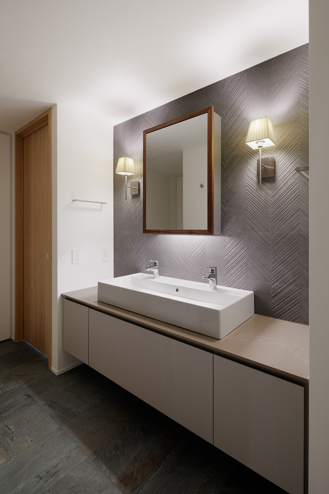 Moderne Gästetoilette mit bunten Wänden, Betonboden, Aufsatzwaschbecken und grauem Boden in Tokio