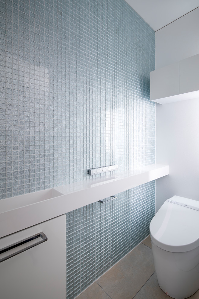 This is an example of a small modern cloakroom in Osaka with white cabinets, glass tiles, porcelain flooring, solid surface worktops, grey floors and white worktops.