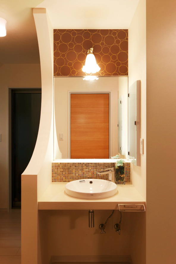 Example of a small minimalist powder room design in Other with open cabinets, beige countertops, multicolored walls and a drop-in sink