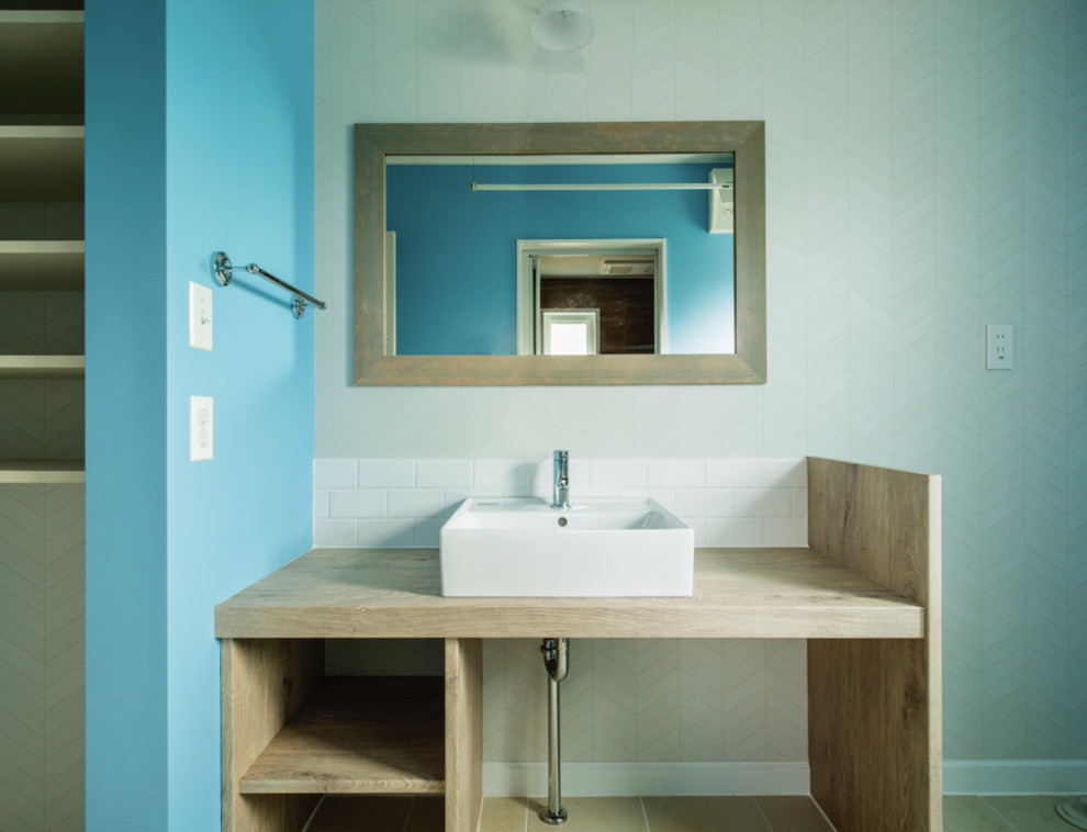 Photo of a large nautical cloakroom in Other with open cabinets, white tiles, metro tiles, white walls, cement flooring, laminate worktops and beige floors.