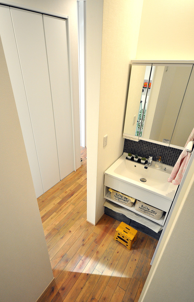 Modern cloakroom in Other with medium hardwood flooring and brown floors.