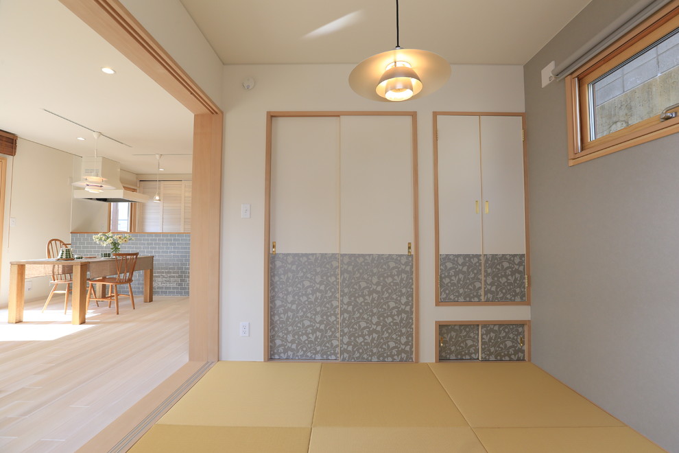 Стильный дизайн: изолированная гостиная комната в восточном стиле с серыми стенами, татами и бежевым полом - последний тренд