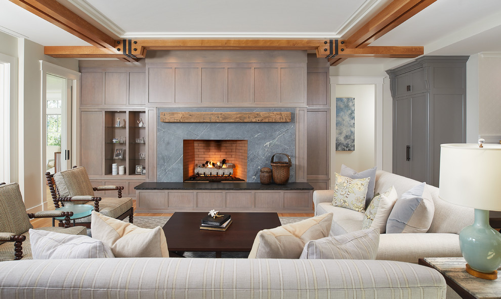 This is an example of a medium sized classic open plan games room in Detroit with beige walls, medium hardwood flooring, a standard fireplace, a stone fireplace surround, no tv and brown floors.