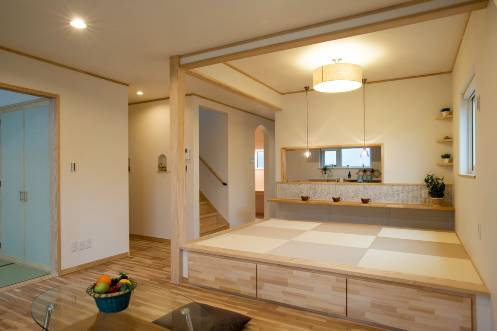 Zen tatami floor and beige floor family room photo in Other with white walls