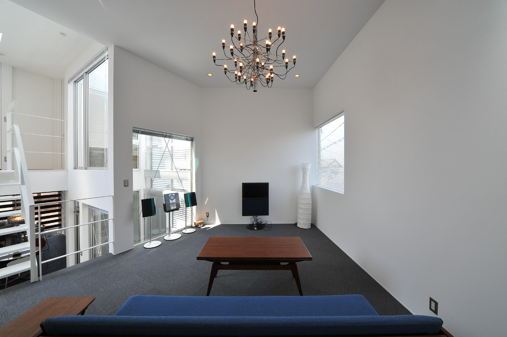This is an example of a contemporary games room in Nagoya with white walls, carpet and a freestanding tv.
