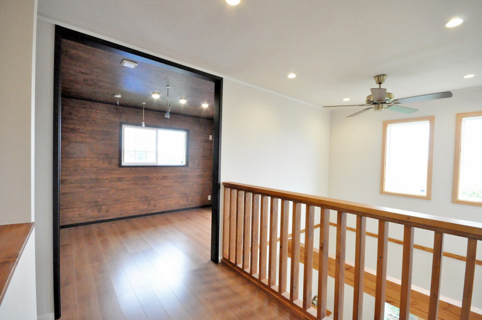 Стильный дизайн: гостиная комната среднего размера с коричневыми стенами, полом из фанеры и коричневым полом без камина, телевизора - последний тренд