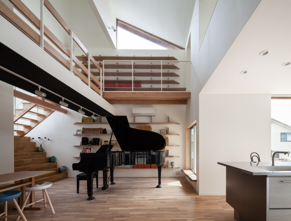 Idee per un soggiorno design di medie dimensioni e aperto con sala della musica, pareti bianche, pavimento in legno massello medio e nessuna TV