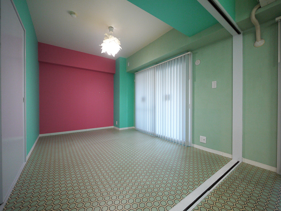 This is an example of a mediterranean open plan games room in Tokyo with pink walls, vinyl flooring and green floors.