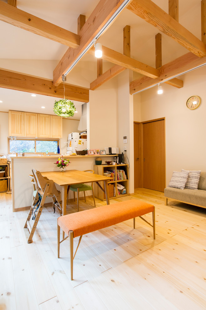 Imagen de sala de estar campestre con paredes blancas, suelo de madera clara y suelo marrón