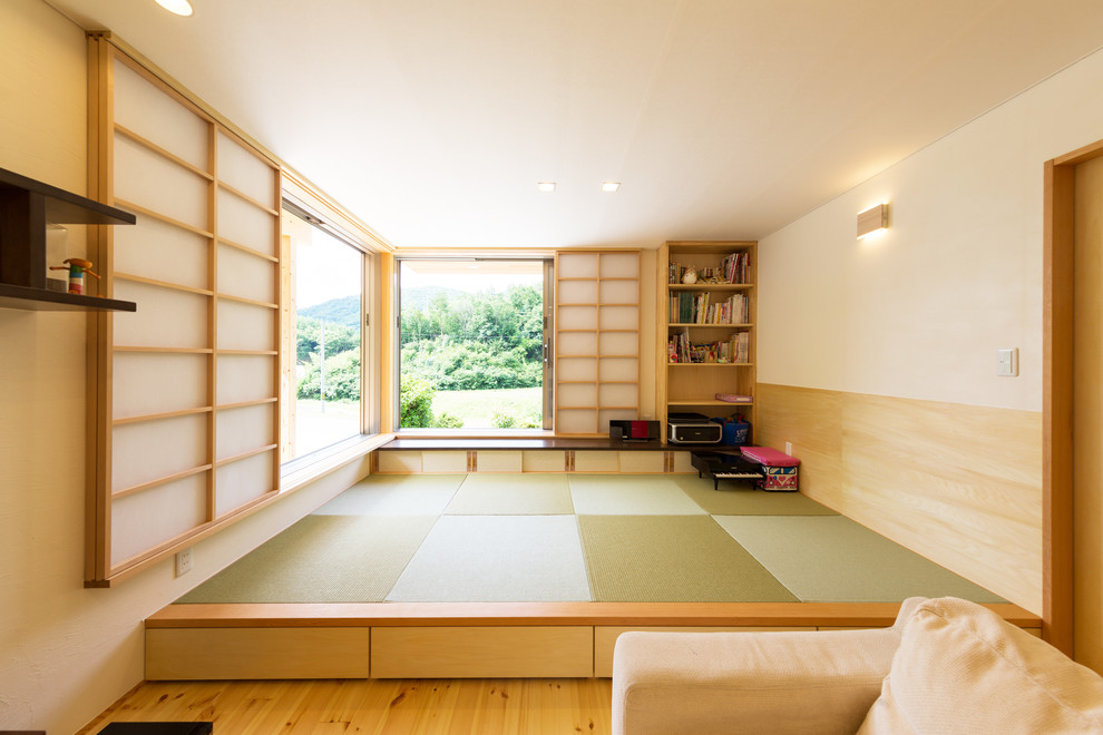 Family room - asian tatami floor and green floor family room idea in Other with white walls
