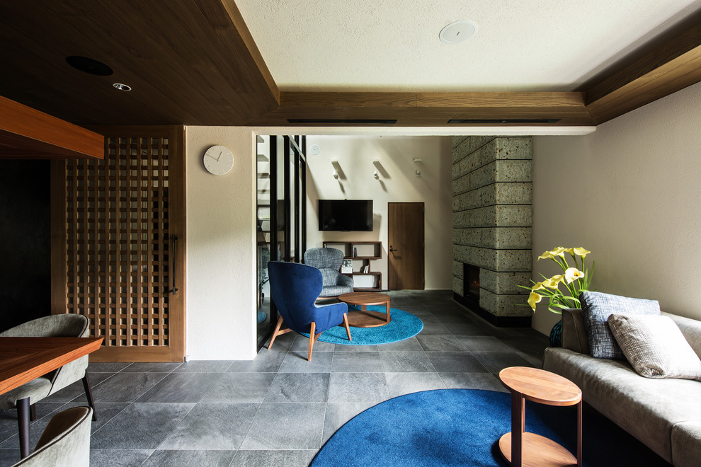 大阪にあるラグジュアリーな広いモダンスタイルのおしゃれな独立型ファミリールーム (ホームバー、標準型暖炉、壁掛け型テレビ、グレーの床、白い壁) の写真