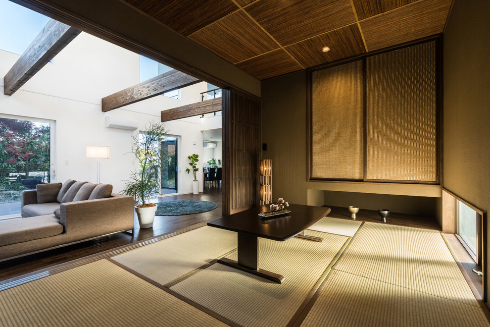 Zen tatami floor and green floor family room photo with gray walls