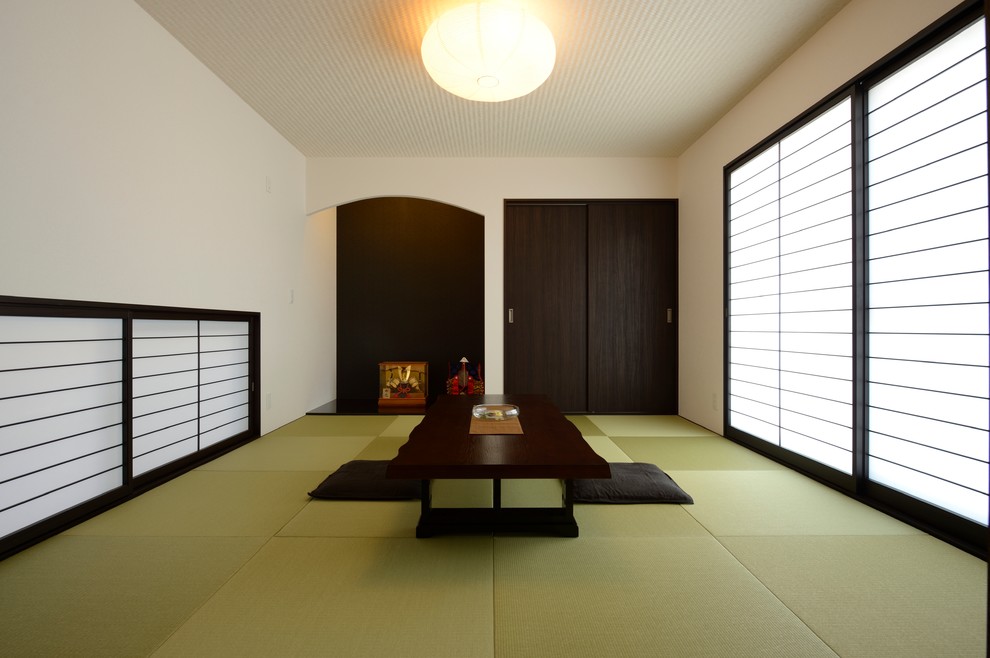 На фото: изолированная гостиная комната среднего размера с белыми стенами и татами без камина, телевизора с