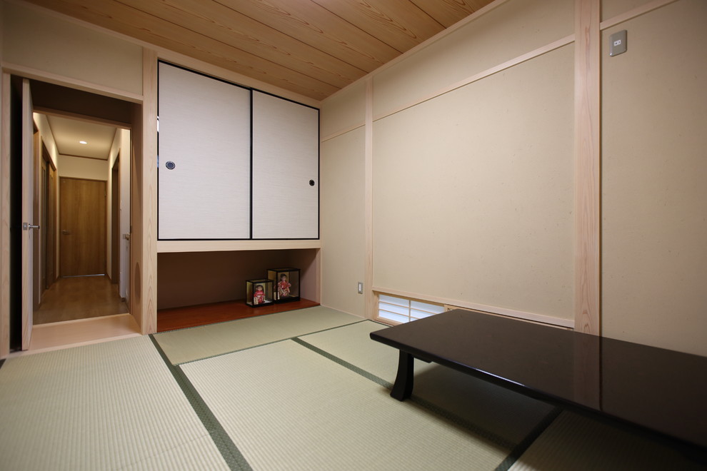 Bild på ett mellanstort orientaliskt avskilt allrum, med ett bibliotek, beige väggar, tatamigolv och grönt golv