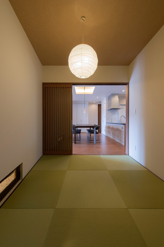 Example of a small zen enclosed tatami floor and green floor family room design in Other with white walls