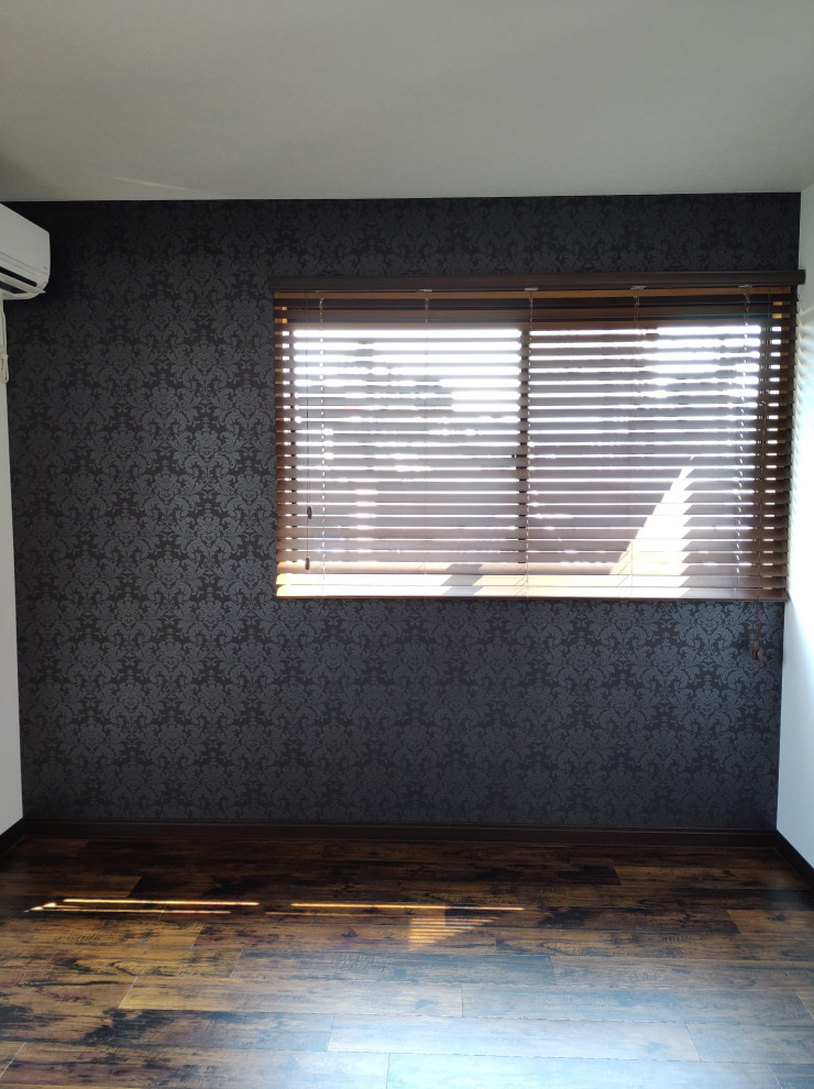 Photo of a small modern enclosed games room in Other with a reading nook, vinyl flooring, a wallpapered ceiling, wallpapered walls, black walls and brown floors.