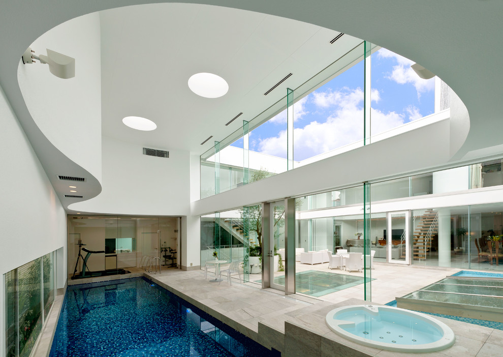 Contemporary indoor rectangular swimming pool in Tokyo with a pool house.
