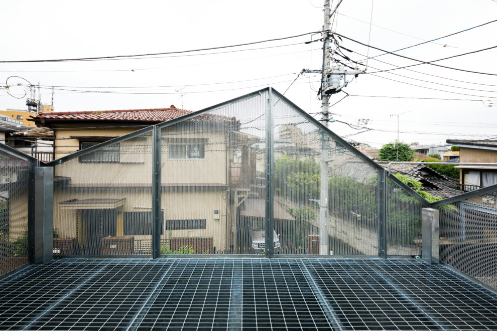 Design ideas for a medium sized modern private metal railing balcony in Tokyo with an awning.