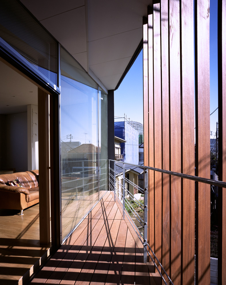 Balcony - small modern privacy and metal railing balcony idea in Tokyo with a roof extension