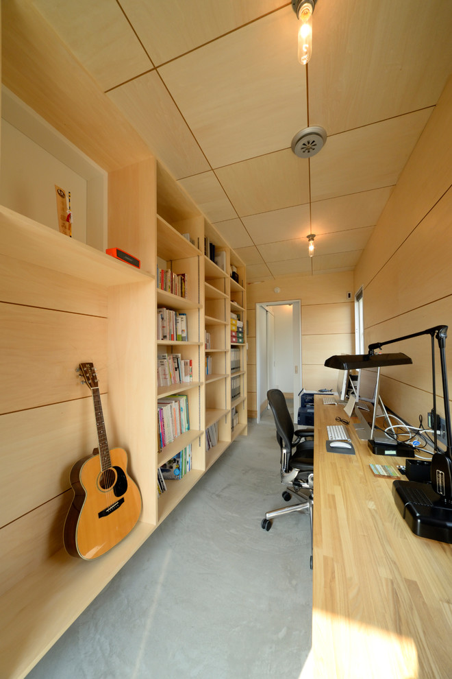 Идея дизайна: кабинет в стиле рустика с бежевыми стенами, встроенным рабочим столом и серым полом