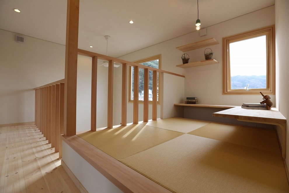 Example of a small danish built-in desk tatami floor study room design in Other with white walls and no fireplace