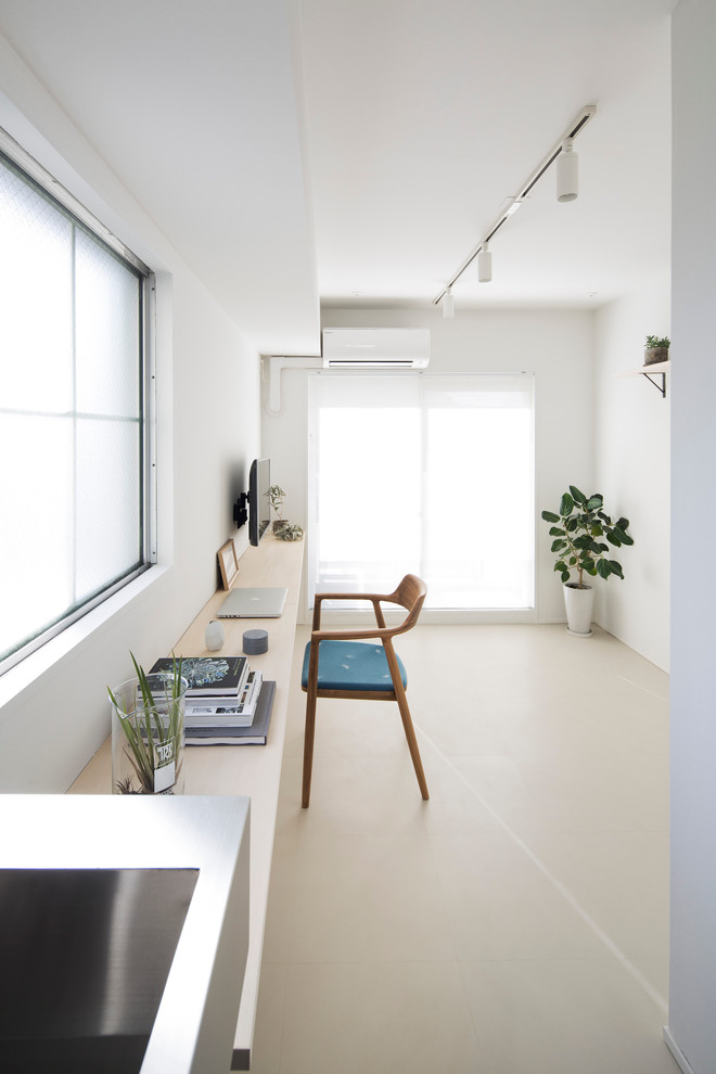 Diseño de despacho escandinavo de tamaño medio con escritorio empotrado, paredes blancas y suelo beige