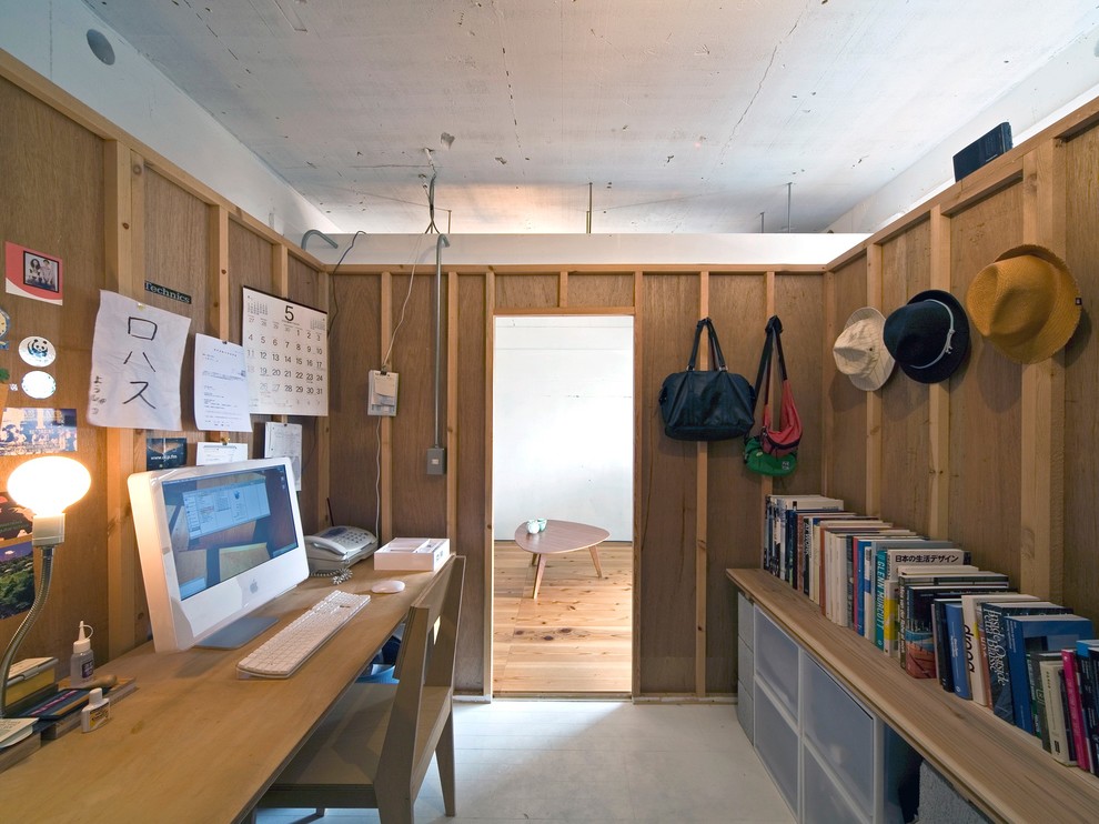 Inspiration for an industrial home office remodel in Osaka with brown walls