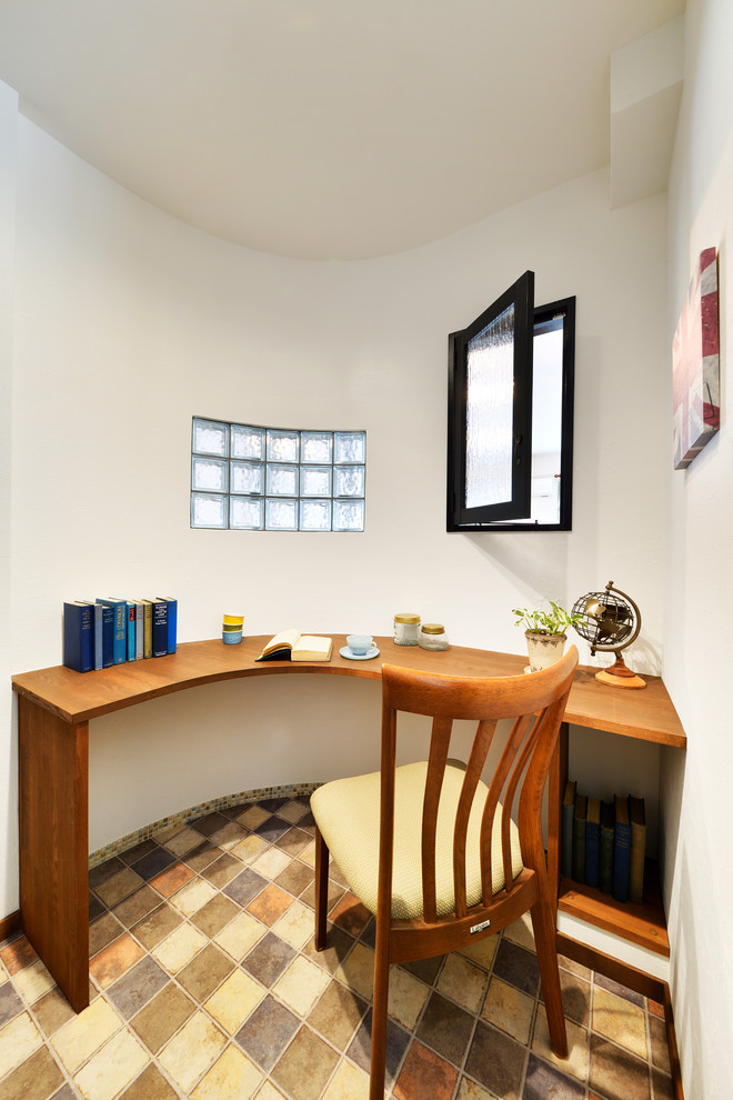 Photo of a scandi home office in Other with white walls, a built-in desk and multi-coloured floors.