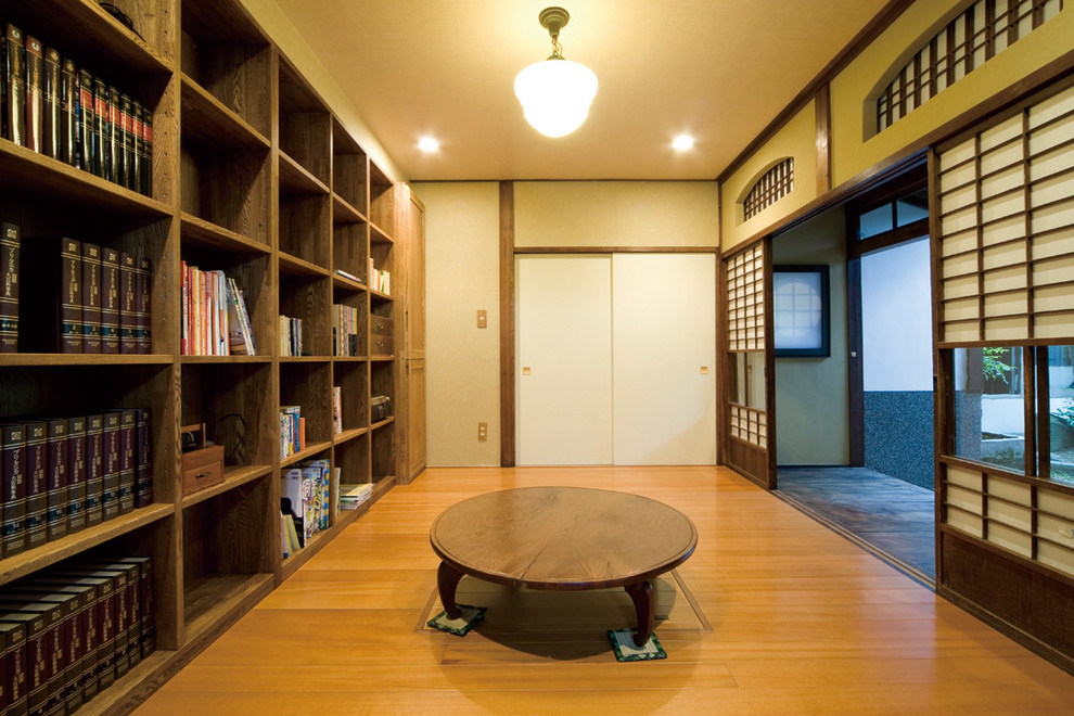 Réalisation d'un bureau asiatique avec un mur beige, un sol en bois brun et un bureau indépendant.