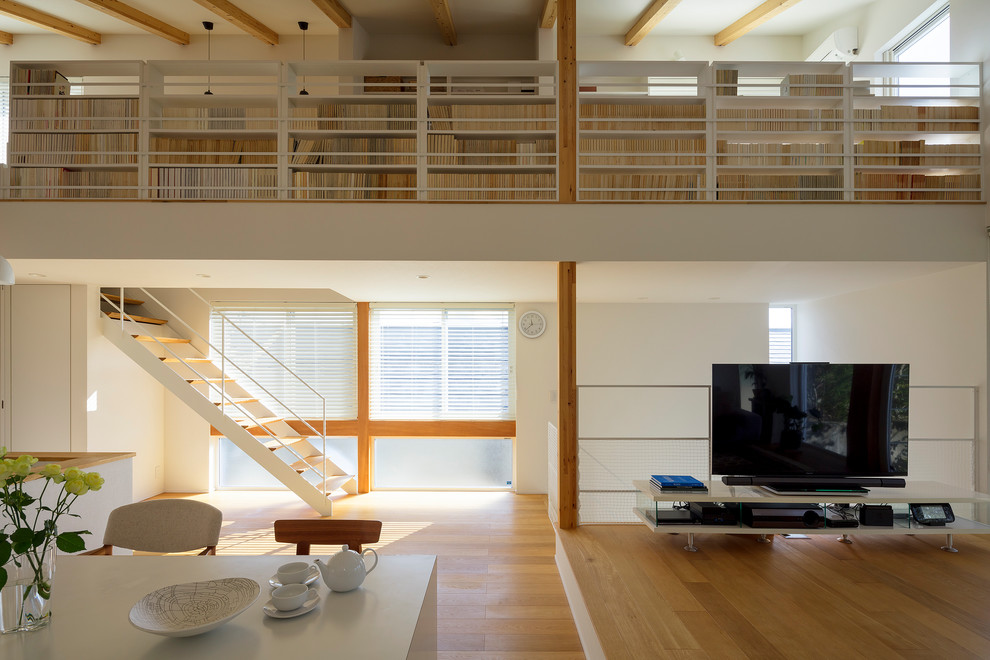 Idée de décoration pour un bureau minimaliste avec une bibliothèque ou un coin lecture et un mur blanc.