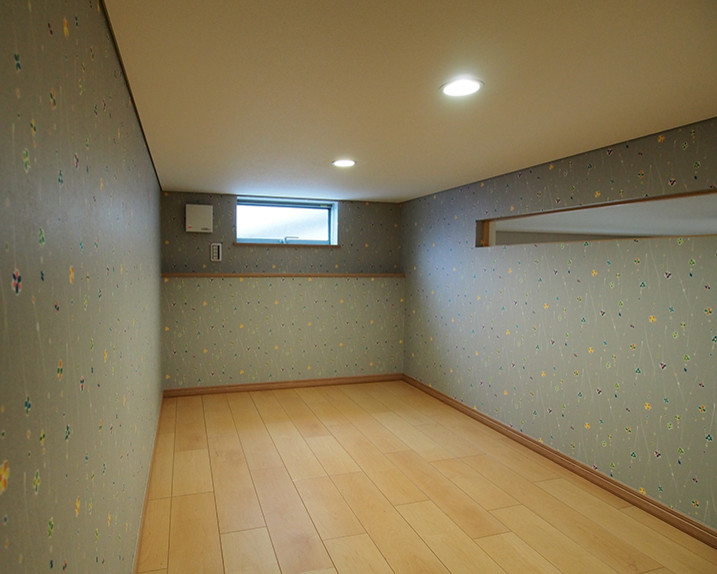 Example of a small minimalist plywood floor and beige floor home office library design in Other with gray walls