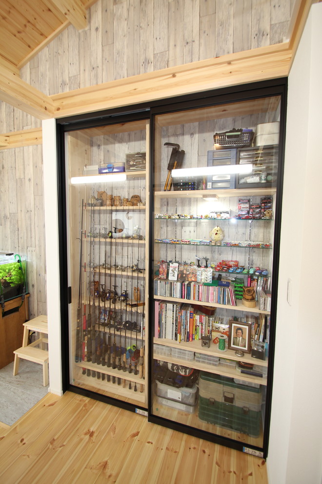 Foto de sala de manualidades industrial de tamaño medio con paredes blancas, suelo de madera clara, escritorio empotrado y suelo beige