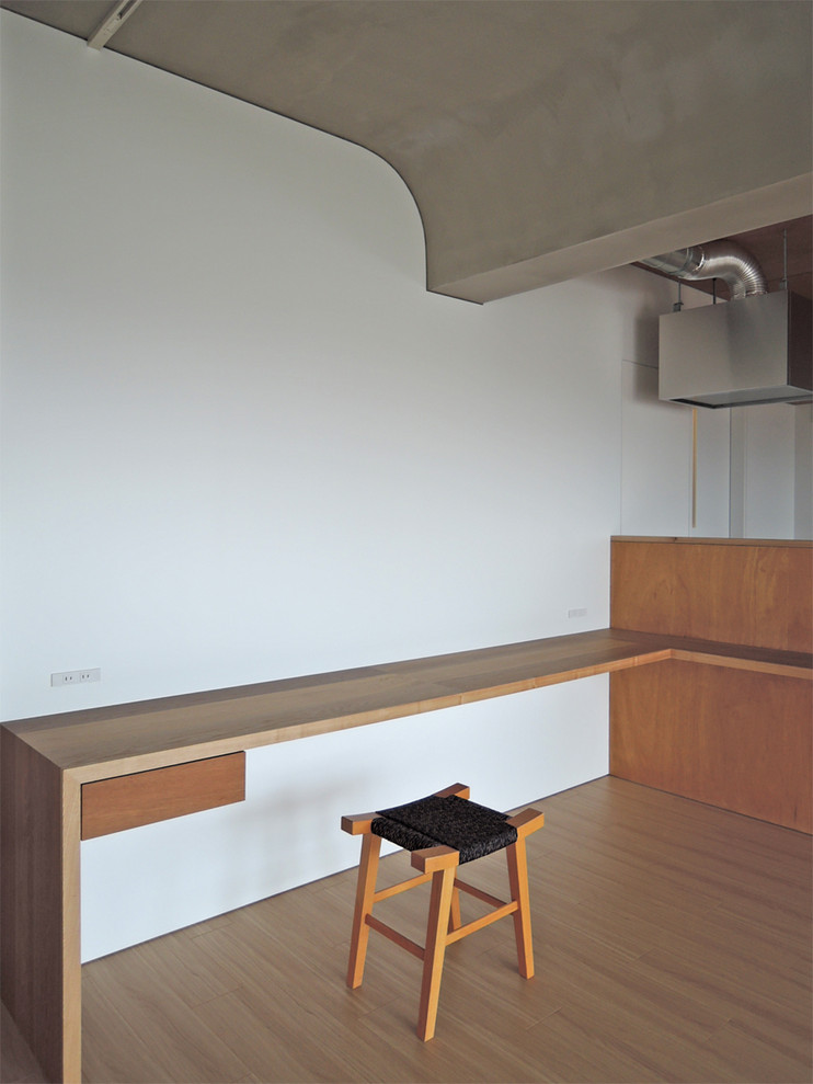 Ispirazione per un ufficio minimalista con pareti bianche, pavimento in compensato, scrivania incassata e pavimento marrone