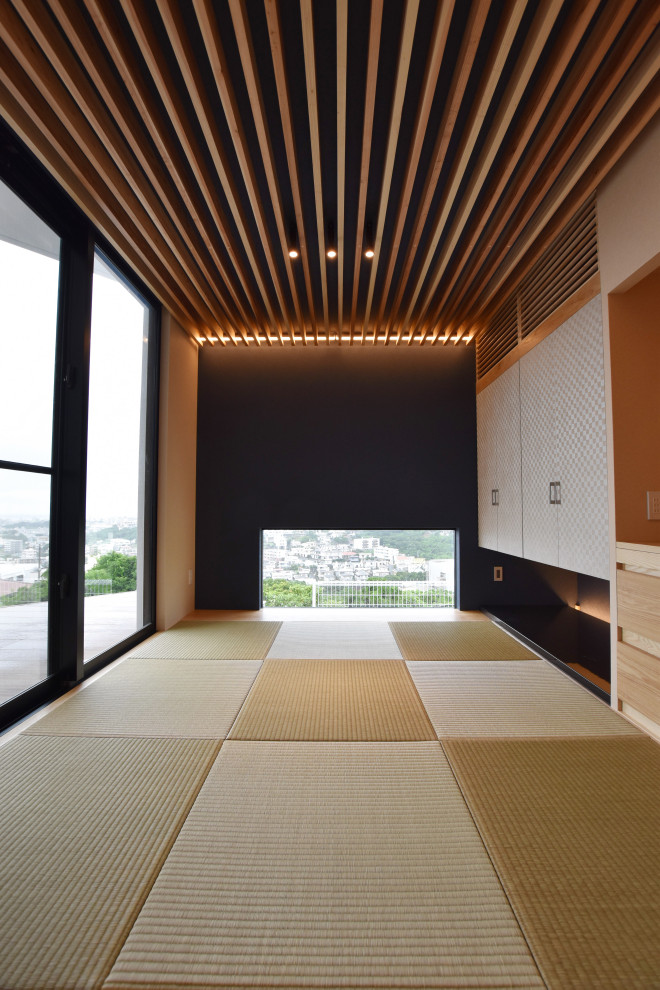 Example of a minimalist tatami floor, beige floor, wallpaper ceiling and wallpaper home office design in Other with black walls and no fireplace