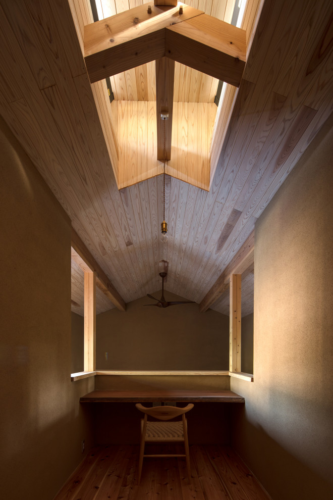 Idée de décoration pour un bureau chalet de taille moyenne avec un mur beige, un sol en bois brun, une cheminée standard, un bureau intégré, un sol beige et un plafond en bois.