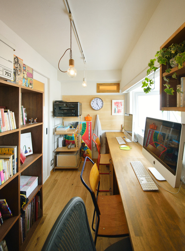 他の地域にあるコンテンポラリースタイルのおしゃれなホームオフィス・書斎 (白い壁、淡色無垢フローリング、自立型机) の写真