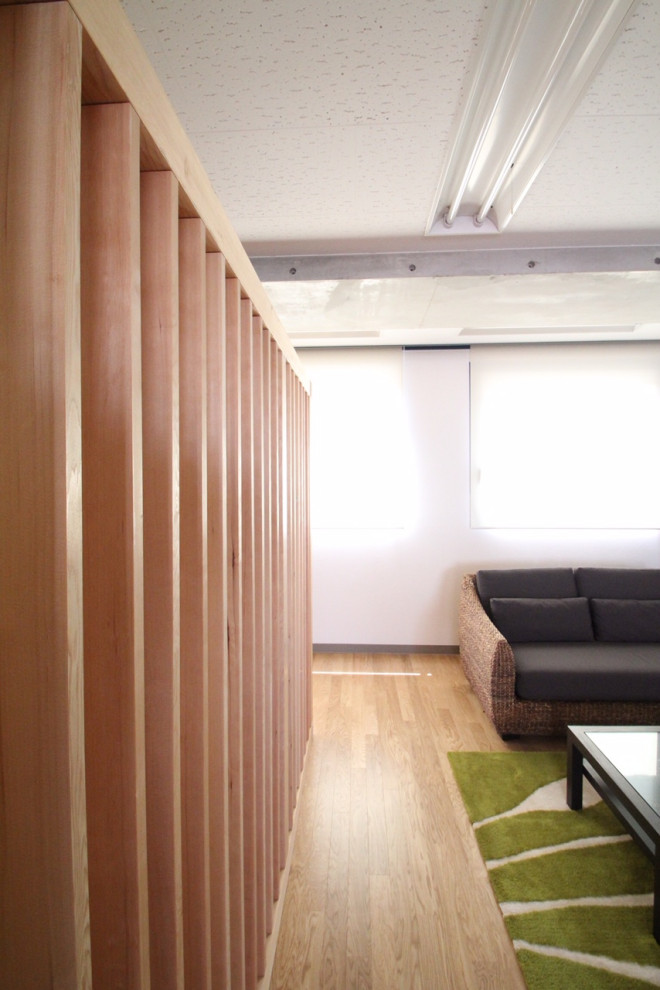 Example of a mid-sized asian freestanding desk light wood floor, brown floor, tray ceiling and wallpaper home studio design in Yokohama with green walls