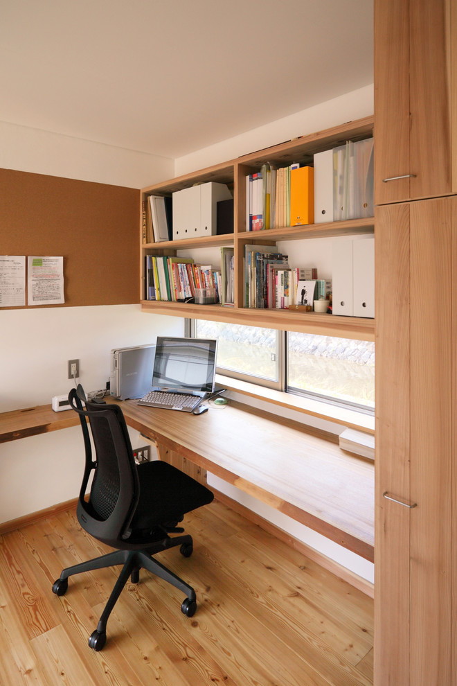 Стильный дизайн: маленький кабинет в восточном стиле с паркетным полом среднего тона, встроенным рабочим столом и коричневым полом для на участке и в саду - последний тренд
