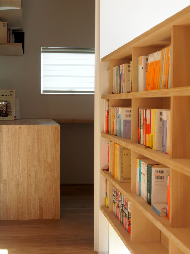 東京都下にあるシャビーシック調のおしゃれな書斎 (茶色い壁、無垢フローリング、造り付け机、茶色い床) の写真