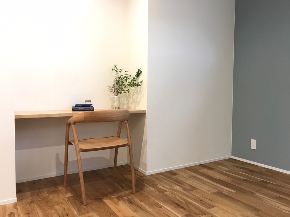 Inspiration for a medium sized scandinavian study in Other with blue walls, medium hardwood flooring, no fireplace, a built-in desk and beige floors.