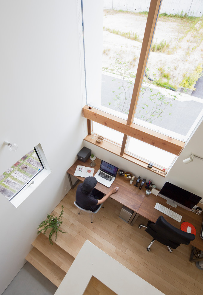 This is an example of a medium sized scandi study in Nagoya with white walls, light hardwood flooring, a freestanding desk and multi-coloured floors.