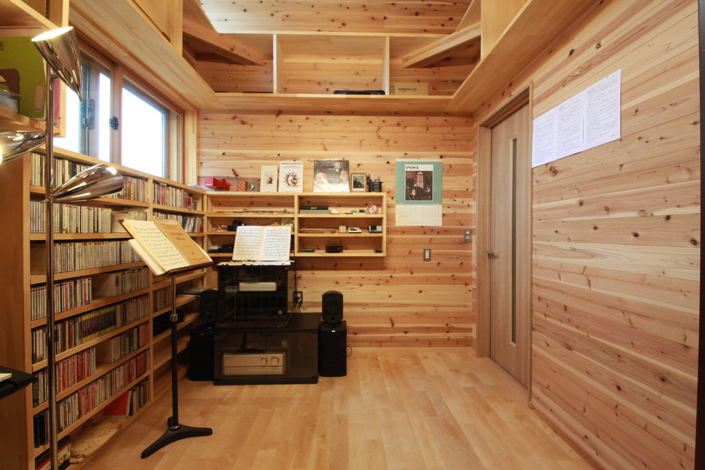 Example of a mountain style light wood floor and brown floor home studio design in Other with brown walls