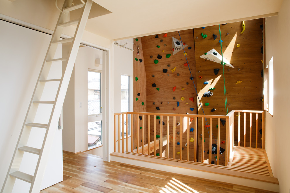 Moderner Fitnessraum mit Kletterwand, brauner Wandfarbe, braunem Holzboden und braunem Boden in Kyoto