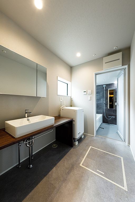 This is an example of a medium sized modern single-wall utility room in Tokyo Suburbs with a built-in sink, open cabinets, wood worktops, white walls, ceramic flooring, an integrated washer and dryer, grey floors and brown worktops.