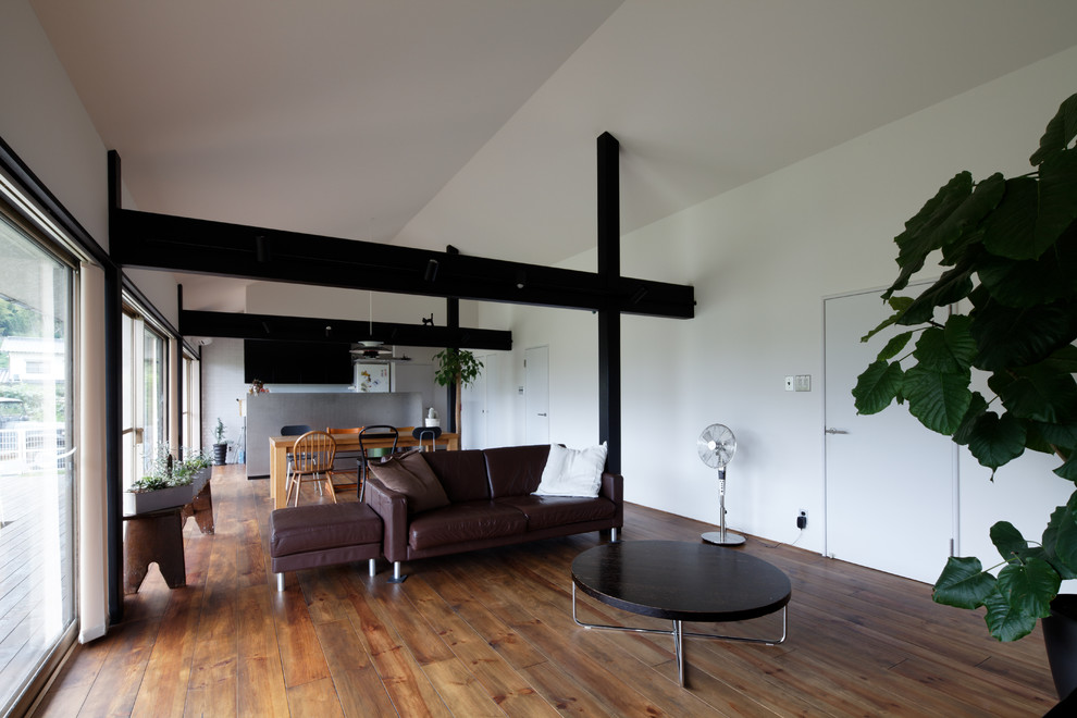 Contemporary open plan living room in Other with white walls, medium hardwood flooring and brown floors.