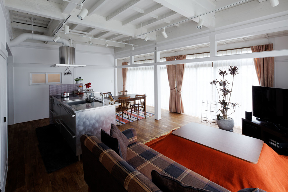 Esempio di un soggiorno industriale di medie dimensioni e aperto con pareti bianche, pavimento in legno massello medio, TV autoportante e pavimento marrone