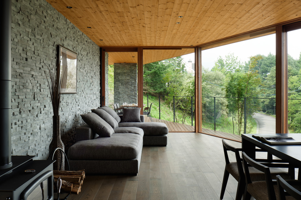 Example of a trendy open concept dark wood floor living room design in Other with gray walls
